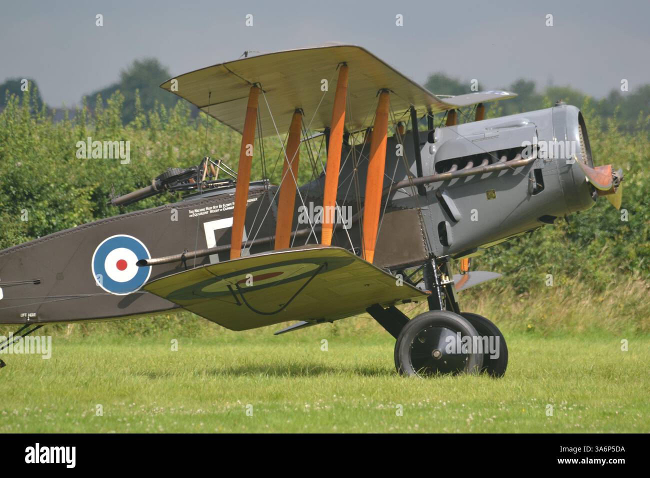 Post‑war F.2B on a grass field; maintenance party with fabric patching frame