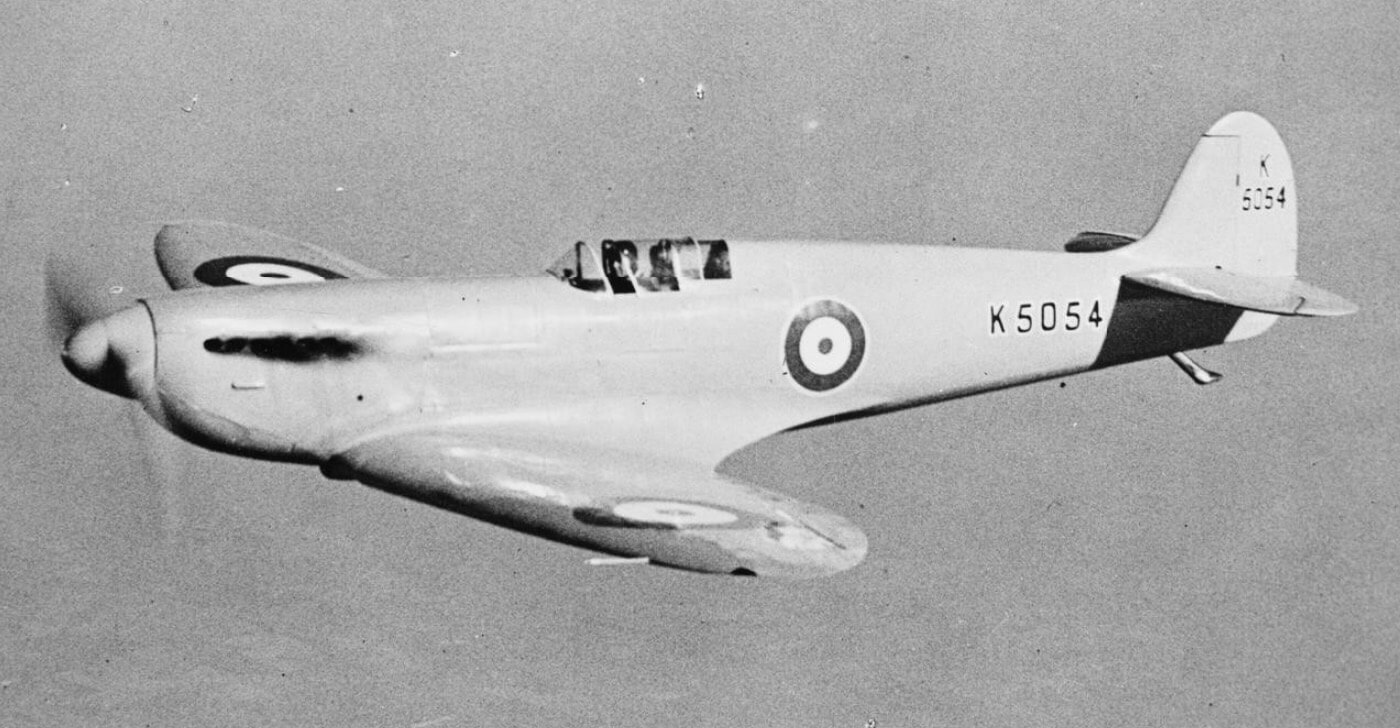 Prototype Spitfire on test apron; ground crew inspecting panels.
